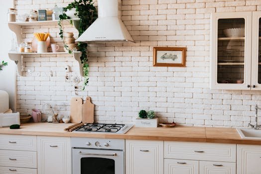 Stylish kitchen interior with modern appliances, wooden counters, and greenery accents.